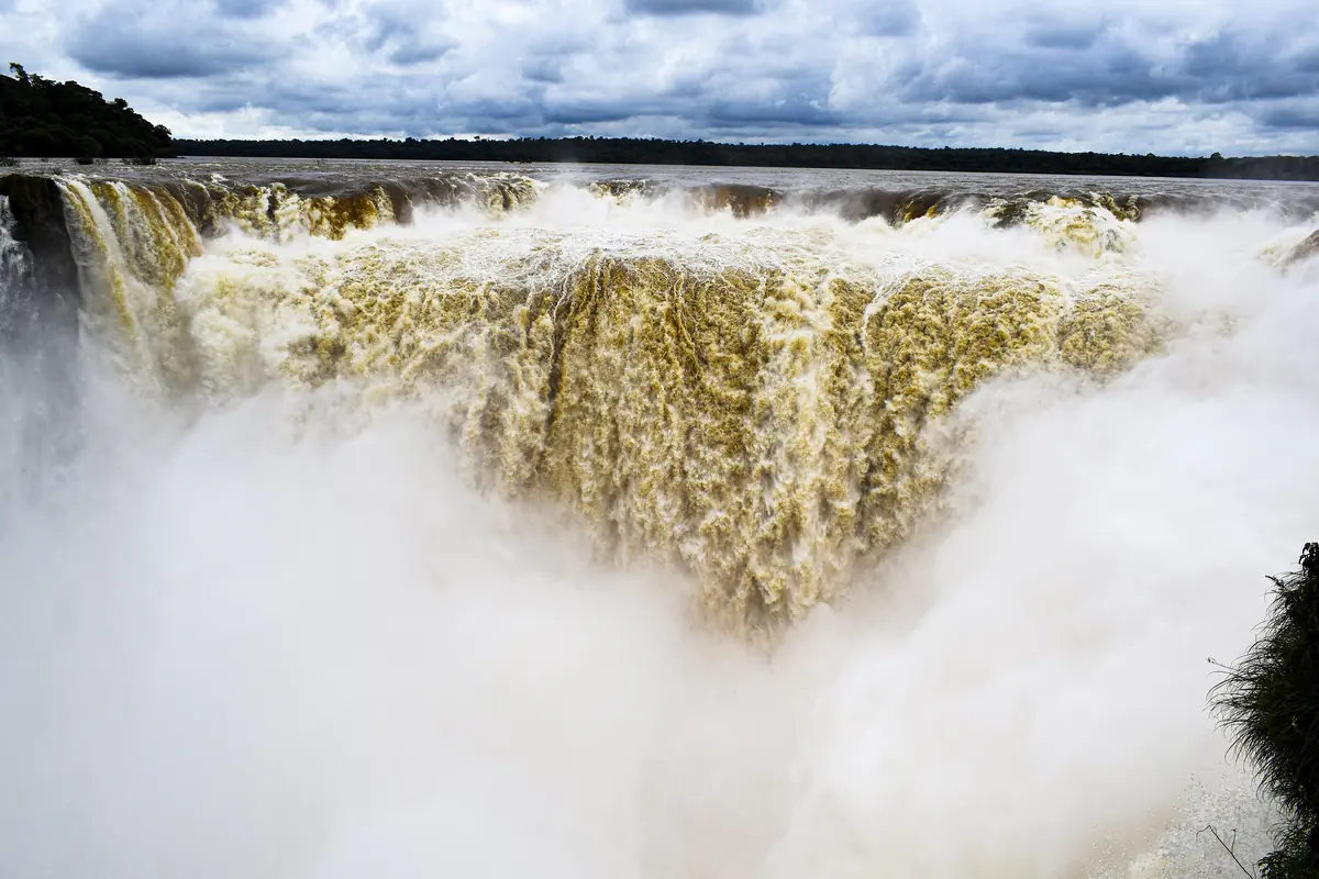 Ďáblův chřtán na vodopádech Iguazú, široká clona hnědé vody padající do bílé mlhy